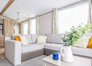 Living area - Modern, stylish and spacious 12ft-wide caravan with one double and two twin. (Selsey, Chichester)
