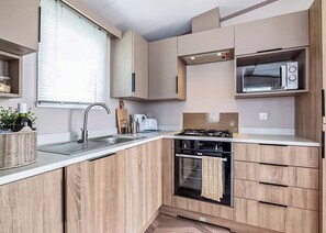 Oven - Modern, stylish and spacious 12ft-wide caravan with one double and two twin. (Selsey, Chichester)