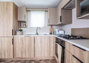 Oven - Modern, stylish and spacious 12ft-wide caravan with one double and two twin. (Selsey, Chichester)