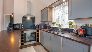 A modern kitchen with a built-in oven, microwave, and coffee maker. - 1 bedroom accommodation in South Duffield, Nr York (South Duffield, Nr York)
