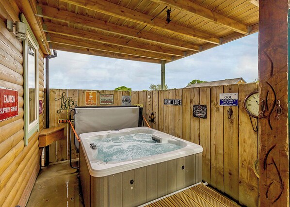 A wooden cabin with a hot tub, wooden walls, and a covered patio. - Luxurious and stylish modern lodge with one master double and one twin. (Haswell, Nr Durham)