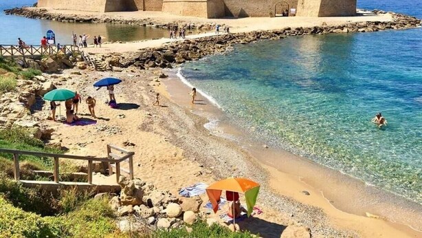 A coastal castle with a beach in front. - LE CASTELLA RESIDENCE APP. 7 (Santa Domenica)
