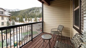 A balcony with a view of a snowy mountain and forest. - Fraser Crossing/Founders Pointe, Condo 1 Bedroom w/Kitchenette Premium Unit 4547 (Winter Park)