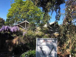 A spa complex with a sign indicating 'Driftwood Inn' and 'Spa Cottages.'