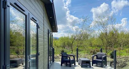 Experience the ultimate retreat in this stunning woodland lodge.