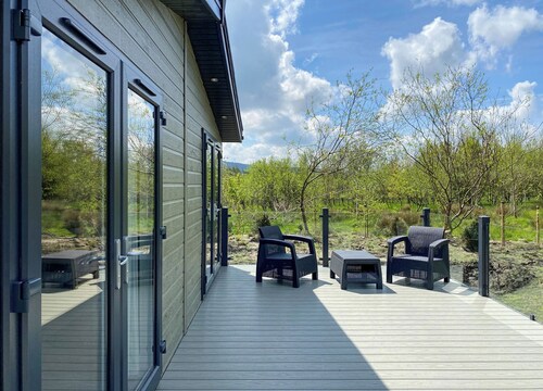 Experience the ultimate retreat in this stunning woodland lodge.