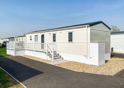 Modern and contemporary 12ft-wide caravan with one double and one twin.