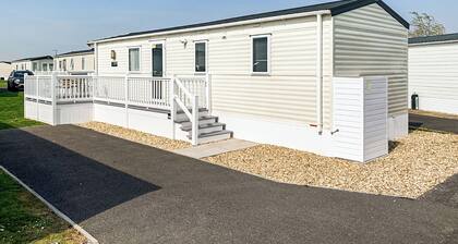 Modern and contemporary 12ft-wide caravan with one double and one twin.