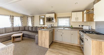Modern and contemporary 12ft-wide caravan with one double and one twin.