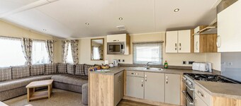 Modern and contemporary 12ft-wide caravan with one double and one twin.