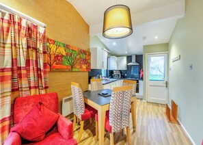 A modern kitchen with white cabinets, a microwave, and a stove.