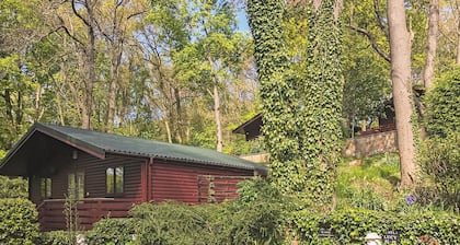 This cosy lodge features one double bedroom and one twin bedroom.