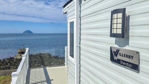 A white mobile home with a window and a sign that reads 'WILLERBY Sheridan.'