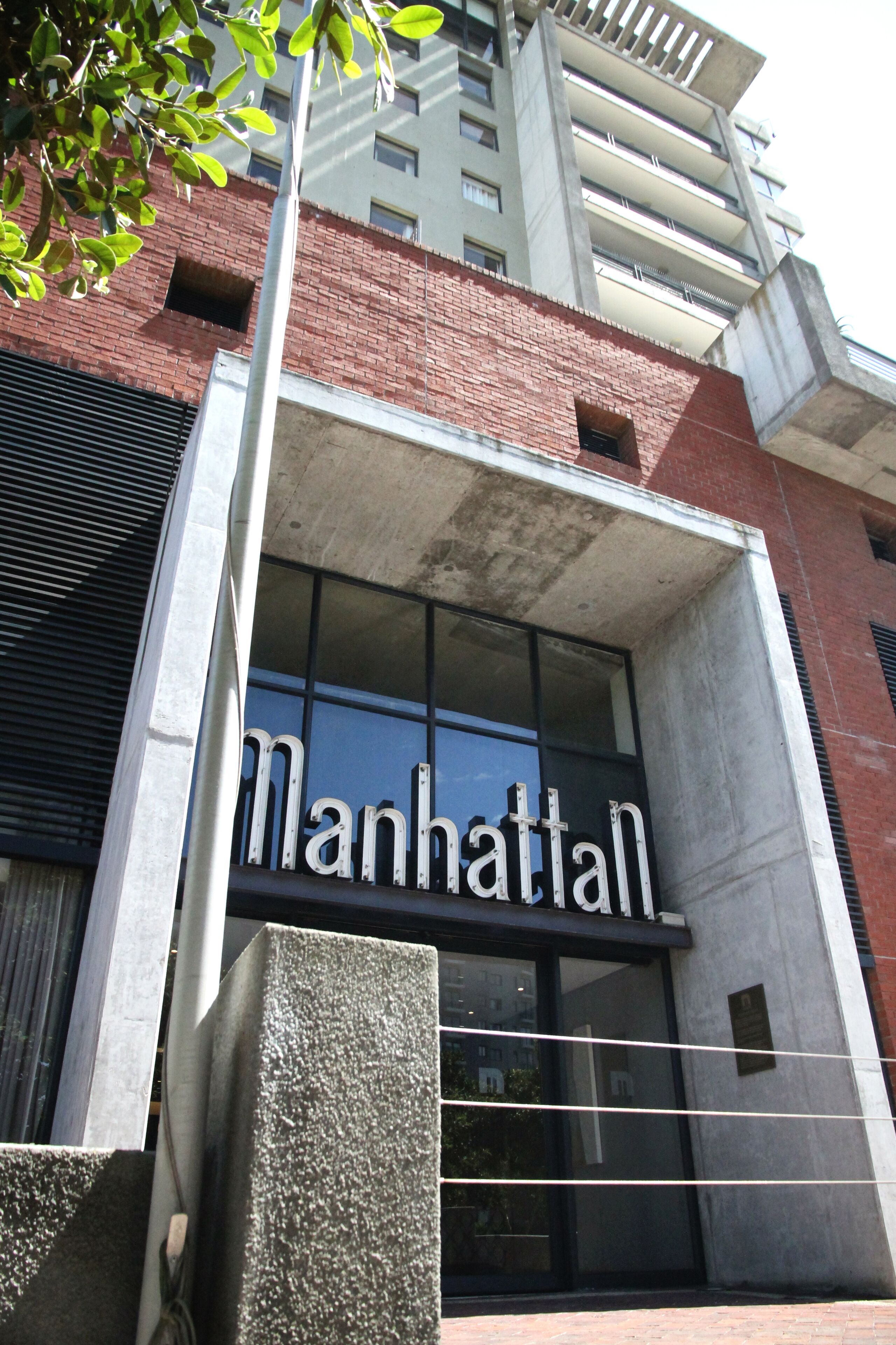 A building with a sign reading "Manhattan" above the entrance.
