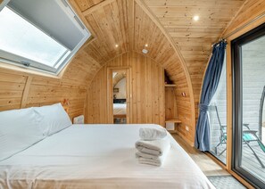 A cozy wooden room with a bed, a window, and a view of the outside. - 0 bedroom accommodation in Great Busby (Great Busby)