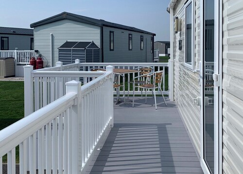 Modern and contemporary 12ft-wide caravan with one double and two twin.