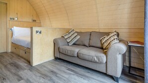 A cozy room with a bed, a sofa, and a small table. - 1 bedroom accommodation in Great Busby (Great Busby)