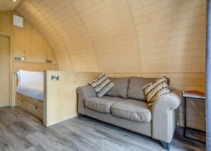 A cozy room with a bed, a sofa, and a small table. - 1 bedroom accommodation in Great Busby (Great Busby)