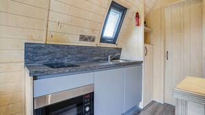 A compact kitchen with a built-in oven, a sink, and a window above the countertop. - 1 bedroom accommodation in Great Busby (Great Busby)