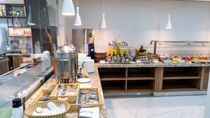 A buffet setup with various food items, condiments, and serving utensils. - Stop Way Hotel Fortaleza (Fortaleza)