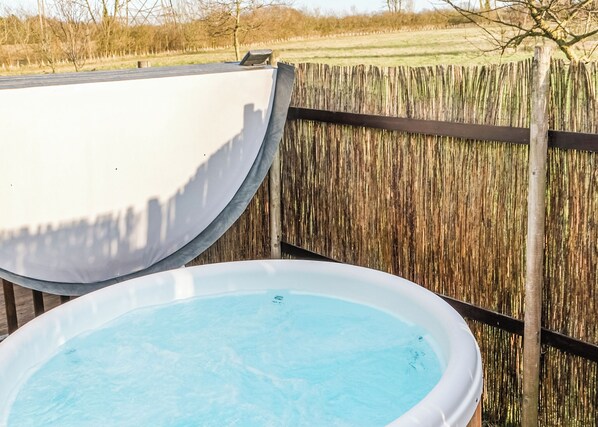 A swimming pool with a wooden fence in the background.