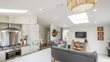 A modern kitchen with a built-in oven and a stainless steel range hood.