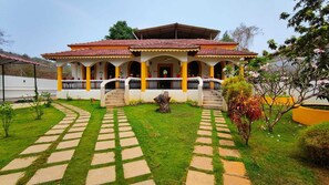 A two-story building with a tiled roof, a covered porch, and a central staircase. - Veda Hotels & Villas (Marra)