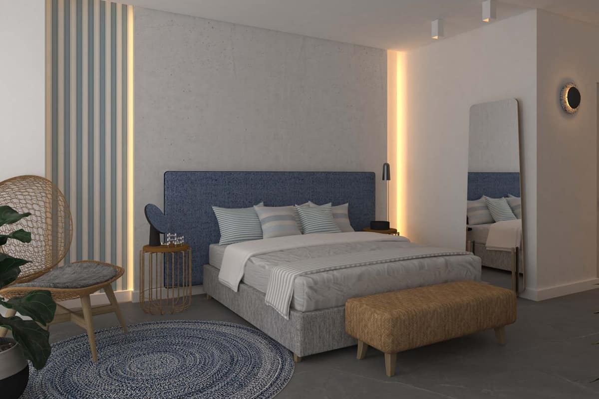 A modern bedroom with a large bed, bedside tables, a chair, a round rug, and a mirror on the wall.