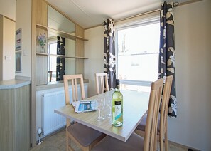 Dining - Stylish 12ft-wide caravan with one double and one twin. (Swanage)