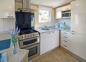 Fridge, oven, stovetop, toaster - Stylish 12ft-wide caravan with one double and one twin. (Swanage)
