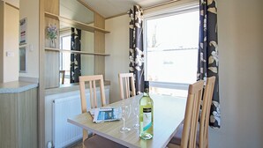 Unclassified image, 5 of 6, button - Stylish 12ft-wide caravan with one double and one twin. (Swanage)