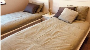 Two single beds with matching headboards and nightstands, each with a lamp. - Modernly Equipped Country House, 5 minutes from Natural Swimming Pools (Altares)