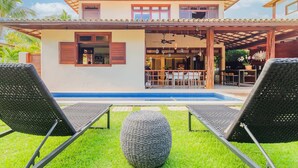 A two-story house with a covered patio, a pool, and outdoor seating. -  PF41 House 6 Bedrooms 300m from the Sea (Mata de São João)