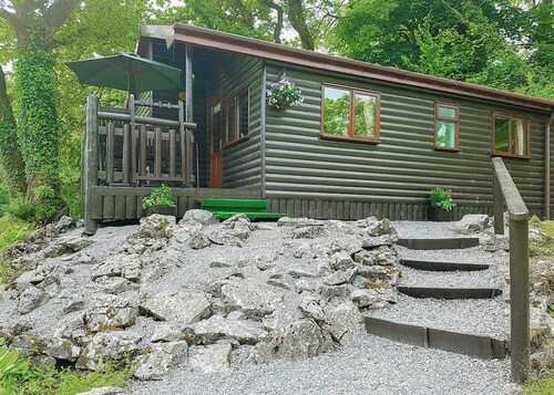 Pine log lodge with one double and one with bunks and a single.