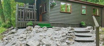 Pine log lodge with one double and one with bunks and a single.