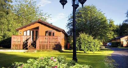 Log cabin with one double with en suite shower and two twin.