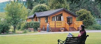 Log cabin with one double with en suite shower and two twin.