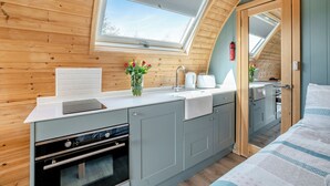 A compact kitchen with a skylight, a built-in oven, and a small dining area. - 0 bedroom accommodation in Great Busby (Great Busby)