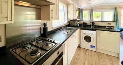 Modern and contemporary lodge style holiday home set in woodland area.