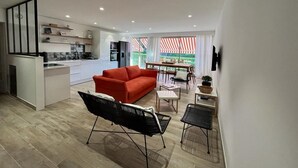 A modern apartment with a kitchen, dining area, and living room.