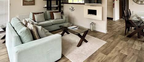 A living room with a sofa, coffee table, and a fireplace.