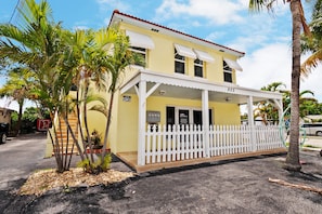 802 House with a covered porch and white picket fence.