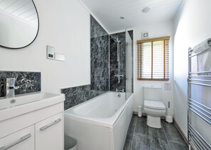 A modern bathroom with a bathtub, toilet, and shower. - Outstanding holiday home offering spacious and comfortable open plan living. (Old Langho, Ribble Valley)