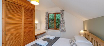 Timber lodge set in an elevated woodland position with one double and one twin.