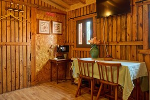 Relax in this inviting room with a dining table, TV, and reading nook.