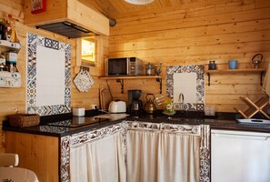 Fridge, microwave, coffee/tea maker, cookware/dishes/utensils