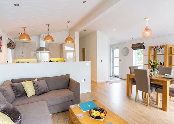 A modern living space with a sofa, dining table, and kitchen area. - 2 bedroom accommodation in Cannington (Cannington)