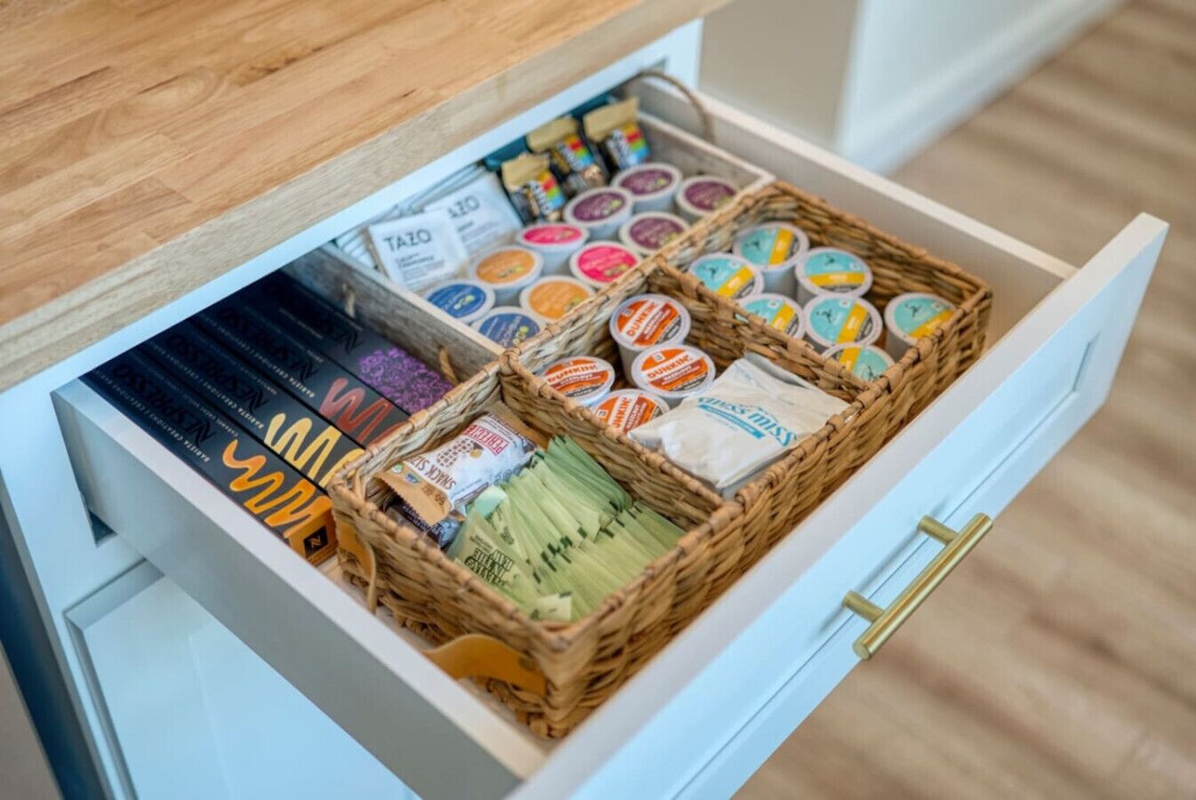A drawer with various food items and snacks, including packaged goods and fresh produce.