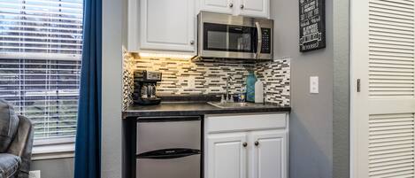 Fridge, microwave, coffee/tea maker, cookware/dishes/utensils