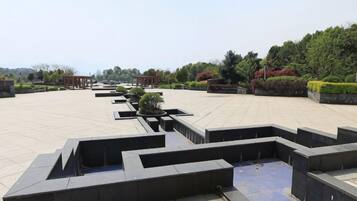 A spacious outdoor area with geometric planters and a clear sky.